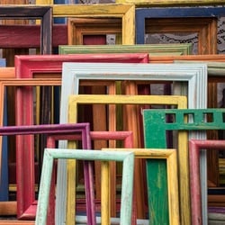 A collection of picture frames of various sizes and colors